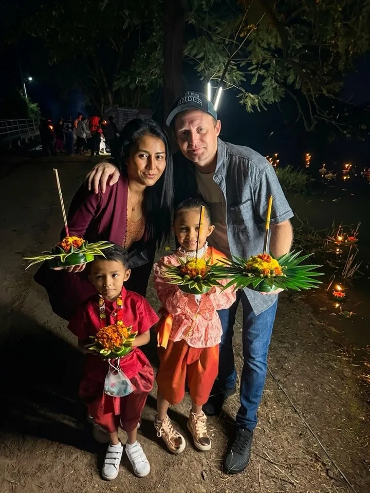 Jason with his wife and two children at a Loy Krathong festival in Thailand